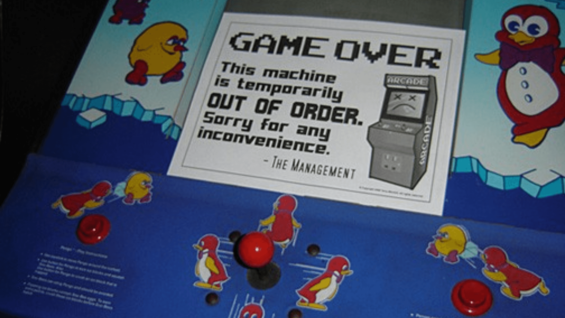 An out-of-order sign hanging on an arcade cabinet.