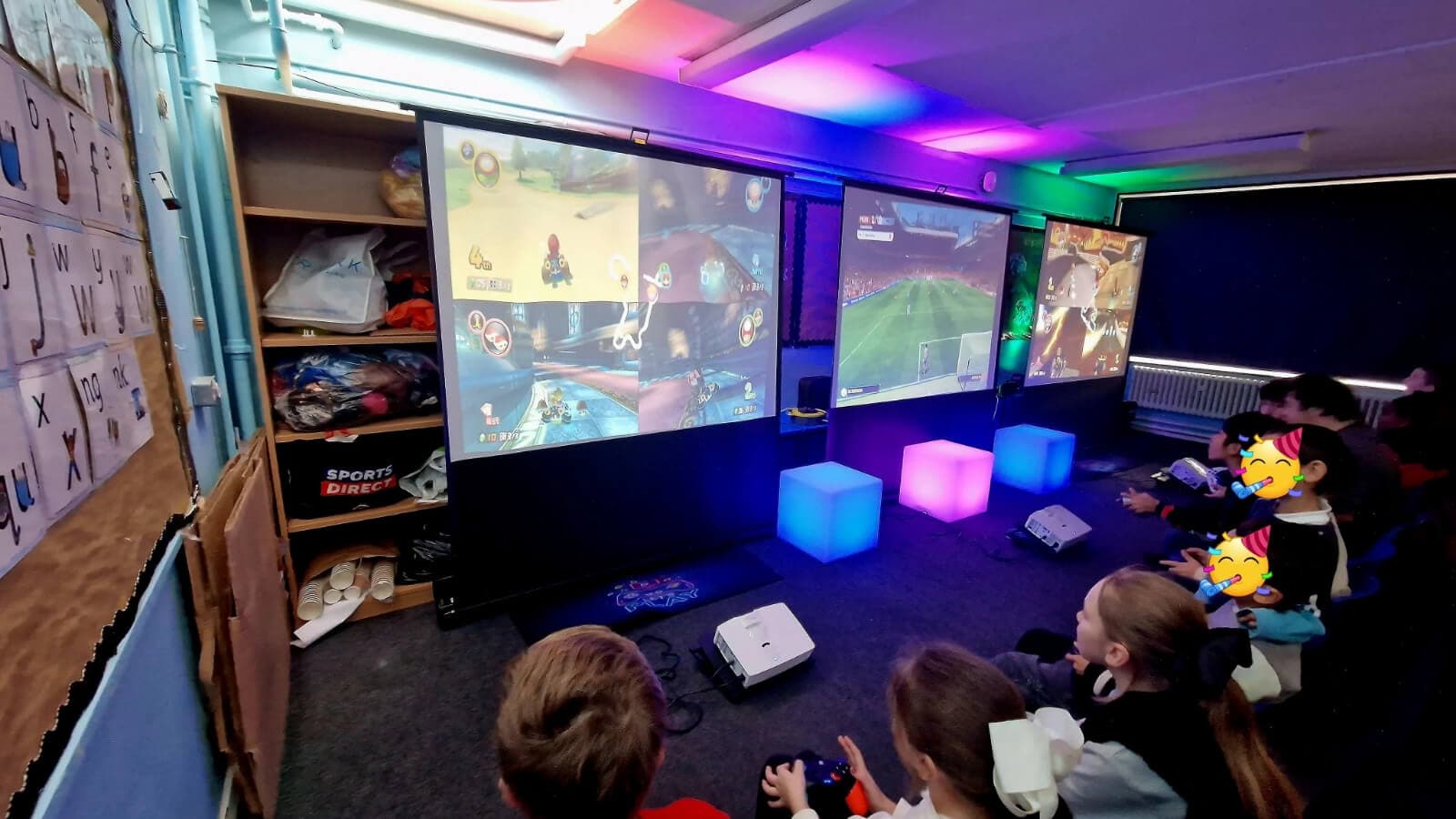 Young players gathering around shared multiplayer games in a modern gaming space.